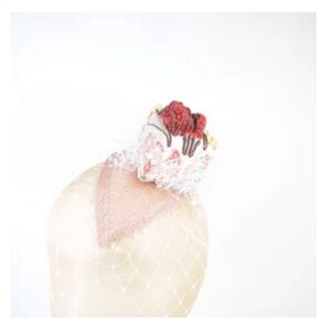 Fascinator headpiece in raspberry cake with white veil